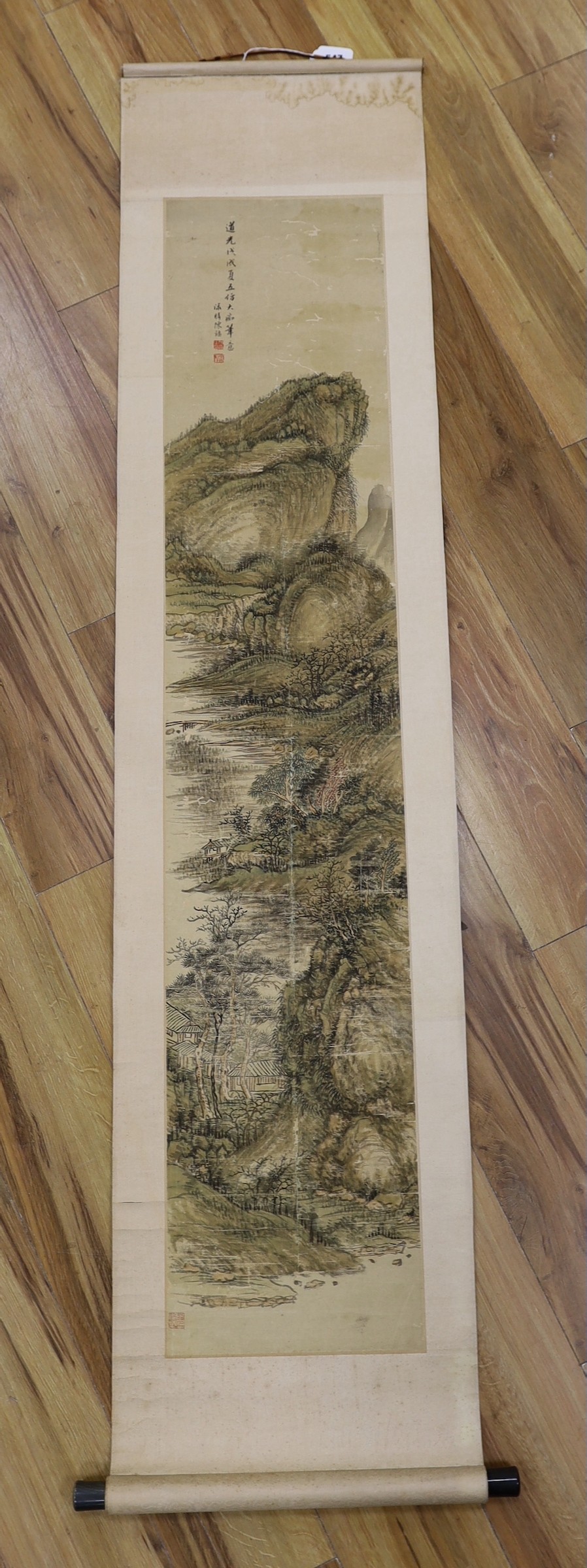 A Chinese landscape scroll painting on silk, Qing dynasty inscribed and signed, artist’s seal and collector’s seal lower left, image 139cm x 27.5cm, remounted